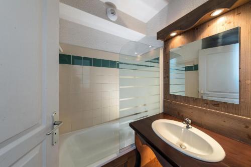 a bathroom with a sink and a mirror and a tub at Charmant appartement 2 Pièces Cabine 4-6 Personnes in Chamrousse