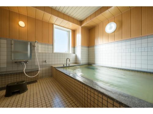 a large swimming pool in a bathroom with at Towada City Hotel - Vacation STAY 85228v in Towada