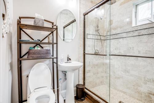 a bathroom with a shower and a toilet and a sink at Elegant Saratoga Springs Stay Walk to Town, Track in Saratoga Springs