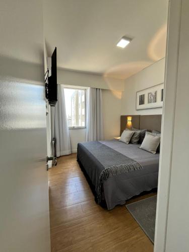 a bedroom with a bed and a television in it at Max Savassi Premier 14 in Belo Horizonte