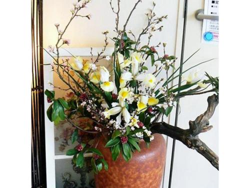 a vase with flowers in it in front of a mirror at Towada City Hotel - Vacation STAY 85232v in Towada