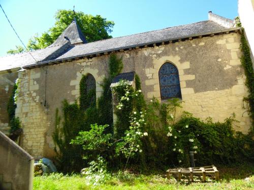 an old stone building with a bench in front of it at Maison charmante à Courchamps avec vue sur jardin in Courchamps