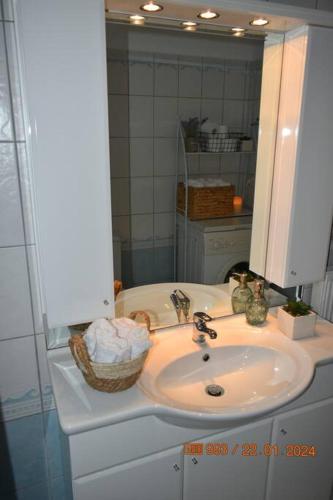 a bathroom with a sink and a mirror at BELLE VUE in Palaiá Panayía