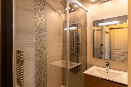 une salle de bain avec un lavabo et une douche en verre dans l'établissement Résidence Les Hauts De Preclaux - Chaleureux appartement neuf au coeur de la station MAE-6054, aux Orres