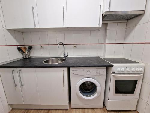 a kitchen with a sink and a washing machine at Calle Mayor, alójate en el centro histórico de Madrid in Madrid