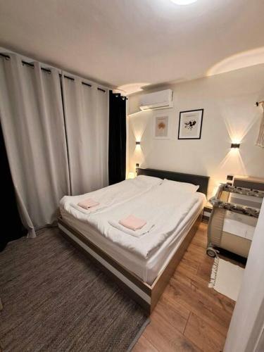 a bedroom with a large bed in a room at White House Apartments in Haskovo