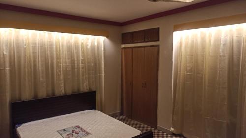 a bedroom with a bed and a closet at Signature Home in Dhaka