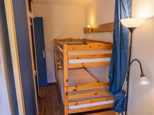 a bunk bed in a small room with a lamp at Résidence Le Belvedere - Studio pour 4 Personnes 564 in Les Orres