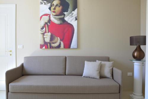 a couch in a living room with a painting on the wall at Dimora storica Santasofia a Martano in Martano