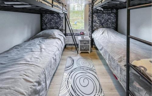a bedroom with two bunk beds and a window at Lovely Home In Lnghem With Kitchen in Länghem