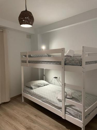 a bedroom with two bunk beds in a room at Barri Vell 4 in Manresa