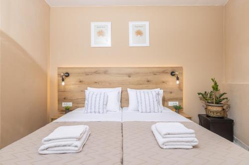 a bedroom with a bed with white towels on it at Sarita's Apartments & Suite in Laganas