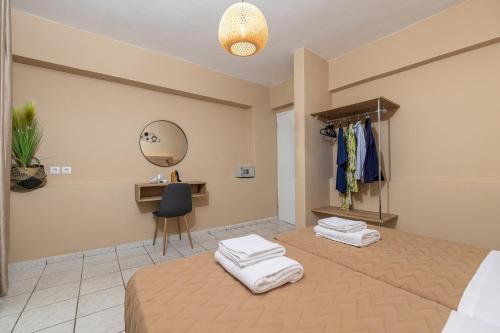 a bedroom with a bed with towels on it at Sarita's Apartments & Suite in Laganas