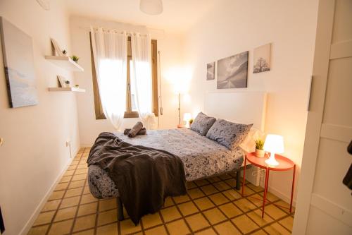 a small bedroom with a bed and a window at Blai in Barcelona