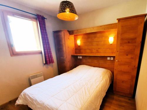 une chambre avec un lit blanc et une fenêtre dans l'établissement Les Chalets Des Rennes - Appartement cosy 2 pièces - Les Chalets Des Rennes MAE-9564, à Vars