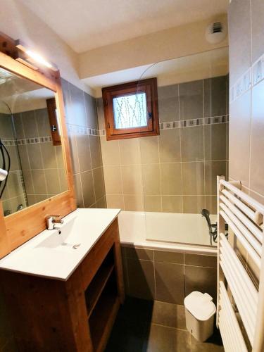une salle de bain avec un lavabo et une baignoire dans l'établissement Les Chalets Des Rennes - Appartement 2 pièces - Les Chalets Des Rennes MAE-9664, à Vars