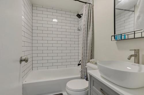 a white bathroom with a sink and a toilet at Housepitality - The Southside Ranch in Columbus