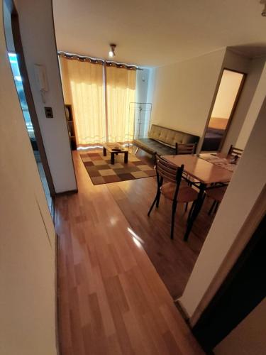 a living room with a table and a couch at Departamento vallenar in Vallenar