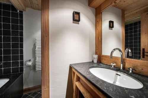a bathroom with a sink and a mirror at Chalet Klosters - Chalets pour 9 Personnes 984 in Val-d'Isère