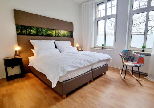 um quarto com uma cama grande e 2 janelas em 135m²-Apartment I max. 8 Gäste I Zentral I Küche I Balkon I Parken I WLAN em Lünen