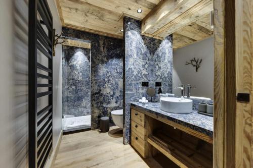 a bathroom with a sink and a toilet at Résidence Cahokia - Chalets pour 13 Personnes 464 in Val-d'Isère