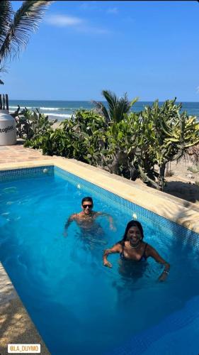 two people in a swimming pool at a resort at Kalua Plateritos in Plateritos