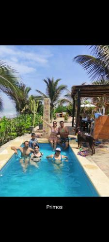 a group of people sitting in a swimming pool at Kalua Plateritos in Plateritos