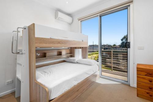 a bedroom with a bunk bed and a large window at Nice & Quiet 2-Bed by Shops & Airport in Melbourne