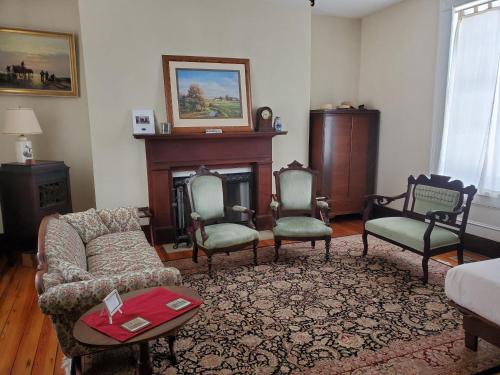 a living room with a couch and chairs and a fireplace at Mountain Home Bed & Breakfast in Front Royal
