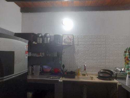 a kitchen with a sink and a microwave at La Nona in Puerto Iguazú