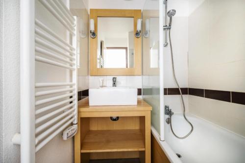 une salle de bain avec un lavabo et une douche dans l'établissement Résidence Port du Crouesty - maeva Home - Appartement 2 pièces 5 personnes - Confort - Vue sur le lac du Miramar MAE-5295, à Arzon