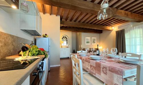 a kitchen with a table with a pink table cloth at Borgo del Silenzio - Apartments with pool in Lajatico in Laiatico