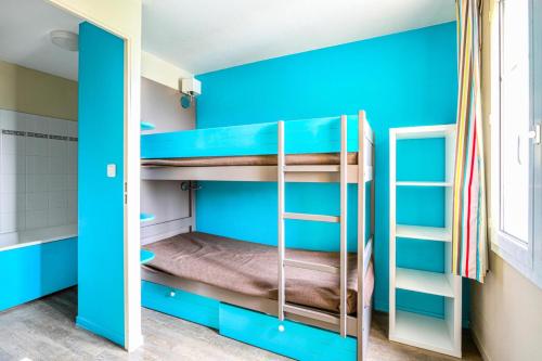 Habitación con literas y paredes azules. en Résidence Port Guillaume - maeva Home - Appartement 2 pièces 6 pers Sélect 51 en Dives-sur-Mer