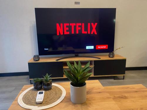 a television screen with the netflix sign on it at WORKATION Centre Airport Boutique Designer Bath, 3-4 days best offer, Kitchen, Balkony, Aircon in Warsaw