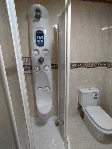 a small bathroom with a toilet and a shower at Casa Rural La Maestra in Sigüés