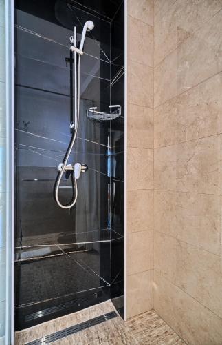 a shower with a glass door in a bathroom at Sunset Split Rooms in Podstrana