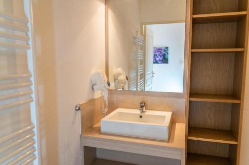 une salle de bain avec un lavabo et un miroir dans l'établissement Résidence Les Terrasses Du Soleil D'or - Agréable duplex avec vue sur les pistes MAE-4534, aux Orres