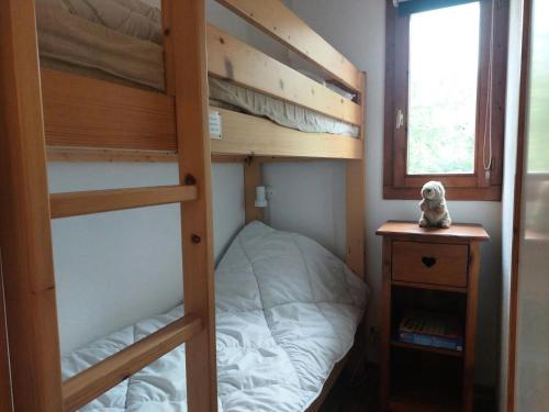 a bedroom with two bunk beds and a window at Résidence Michailles - 2 Pièces pour 4 Personnes 014 in Peisey-Nancroix
