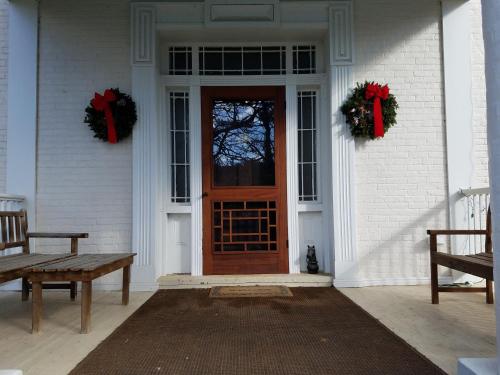 una puerta de entrada de una casa blanca con coronas en Mountain Home Bed & Breakfast en Front Royal