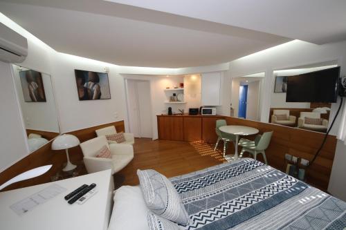 a bedroom with a bed and a living room at Cosy Studio Azores Beach in Ponta Delgada