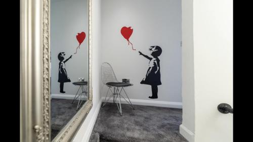 a mirror in a room with a woman holding hearts at The Highfield Chester. in Chester