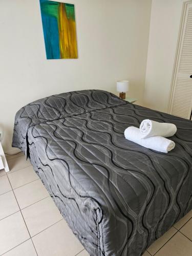 a bed with two towels on it in a room at Centrepoint Resort in Gold Coast