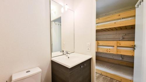 a bathroom with a sink and a mirror at Résidence La Petite Ourse - Studio neuf · Centre station · Balcon MAE-7402 in Flaine