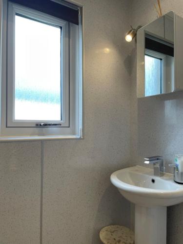 a bathroom with a sink and a window at Hillside View, Inverness in Inverness