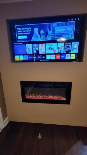 a flat screen tv on a wall with a fireplace at Home Stay in Atlanta