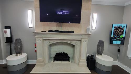 a living room with a fireplace with a tv above it at Home Stay in Atlanta