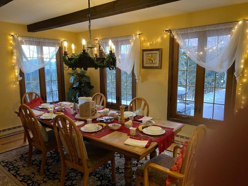 a dining room with a wooden table and chairs at Colorado Bed & Breakfast with beautiful views in Evergreen