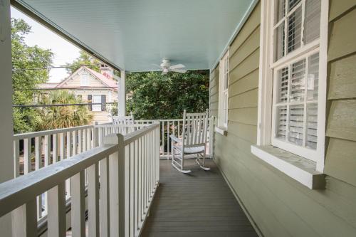 a porch of a house with a chair on it at The Bogard Only 4 Blocks to King in Charleston