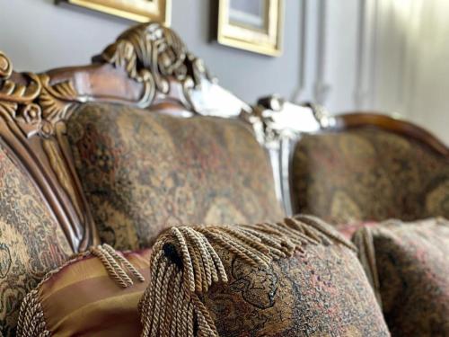 a close up of a couch with a blanket on it at Mikpritja Pogradec, Tushemisht 1 in Pogradec