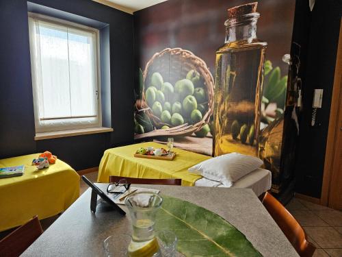 a room with two tables and a painting on the wall at B&B 7 Vizi in Colà di Lazise